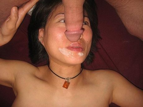 Asian babe with small tits toys her pussy with a dildo after stripping