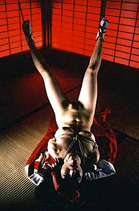 Asian lady in a cage gets her pussy licked and her tits fucked