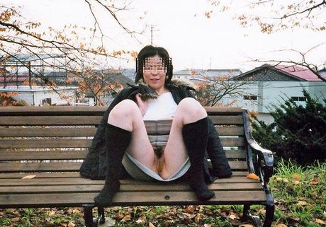 Asian amateur girl strips and shows her hairy cunt in the public place