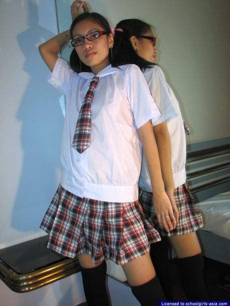 Adorable college student lifting her school skirt to flash her soft peach