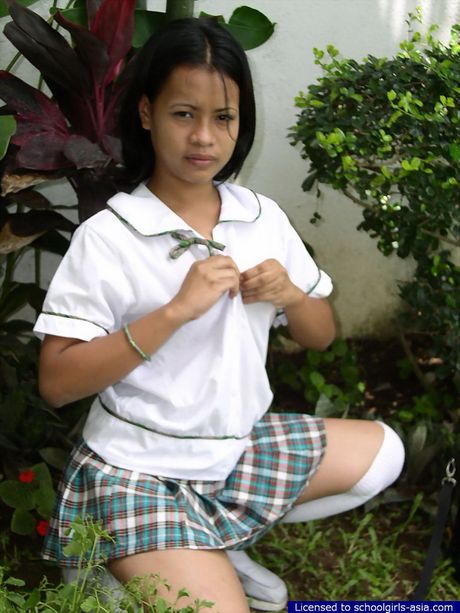 Very cute Asian student stripping outdoors to flash her bald pussy