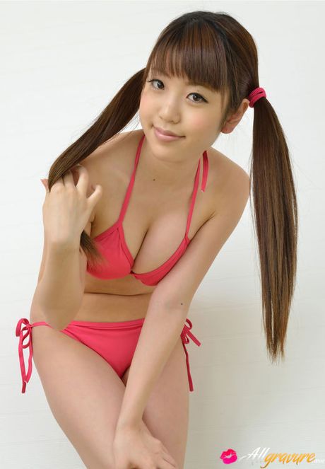 Mizuho Shiraishi with cans in pink bath suit plays with her hair