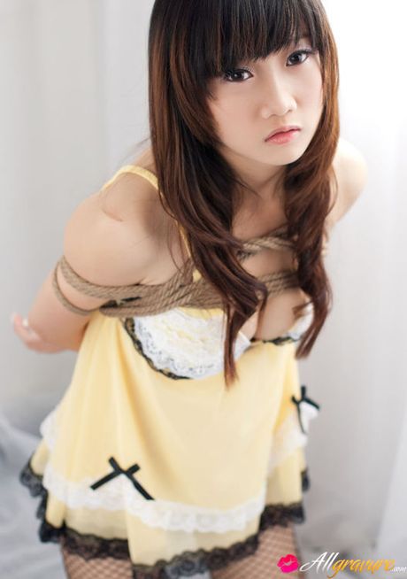 Miko Asian doll in fishnets has hands and boobies tied with ropes