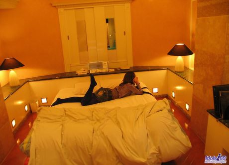 Asian slut removes her clothes and masturbates her hairy pussy with a large toy